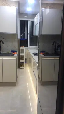 a large kitchen with white counters and white cabinets at Appartement Prestige à Rabat Océan - 2min de la Plage in Rabat