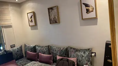 a living room with a couch with pillows at Appartement Prestige à Rabat Océan - 2min de la Plage in Rabat