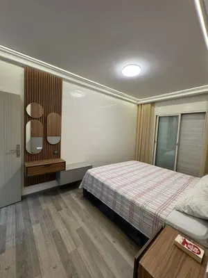 a bedroom with a bed and a table in it at BellaVita in Casablanca