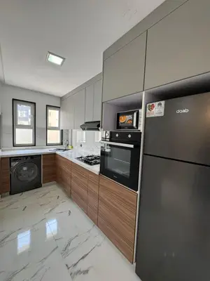 a kitchen with stainless steel appliances and wooden cabinets at BellaVita in Casablanca