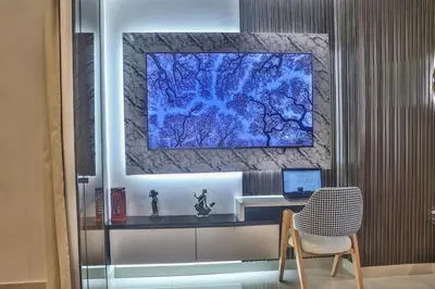 a desk with a chair and a computer on a wall at Studio Luxe avec Vue sur la Corniche in Casablanca