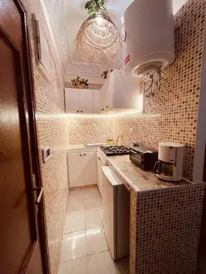 a small kitchen with white cabinets and a counter top at Beautiful Studio in Casablanca in Casablanca