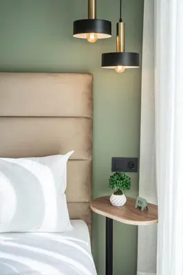 a bedroom with a bed and two lights and a table at Studio palmier TR3 in Casablanca