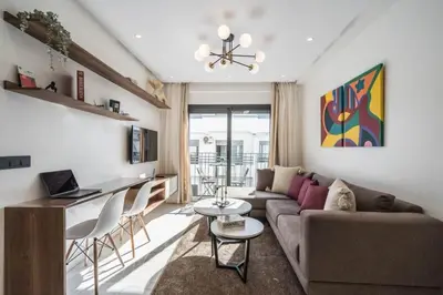 a living room with a couch and a table at Studio palmier TR3 in Casablanca