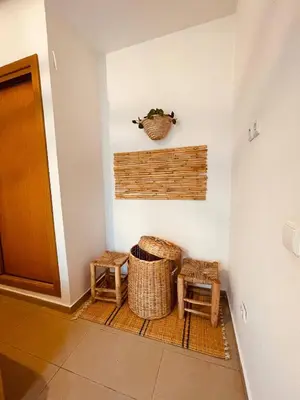 a hallway with two baskets and two stools at Havre de Paix in Casablanca in Casablanca