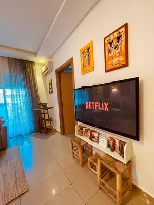 a living room with a flat screen tv on a wall at Havre de Paix in Casablanca in Casablanca