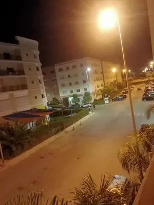 an empty street at night with a street light at Casa sabir in Temara