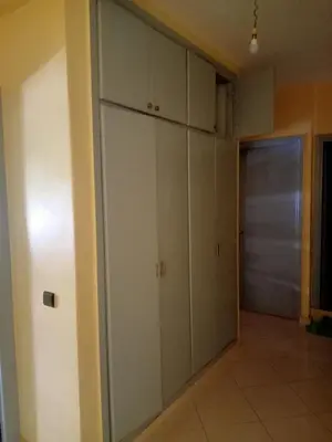 a room with white cabinets and a hallway at Casa sabir in Temara