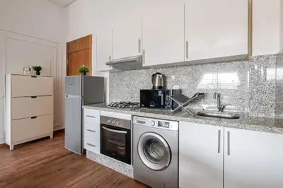 a kitchen with a washing machine and a sink at Cozy studio 5 min Casa port Parking Netflix in Casablanca