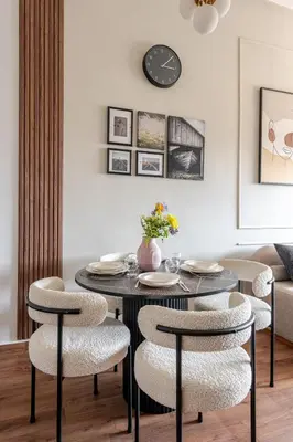 a dining room with a black table and chairs at Cozy studio 5 min Casa port Parking Netflix in Casablanca