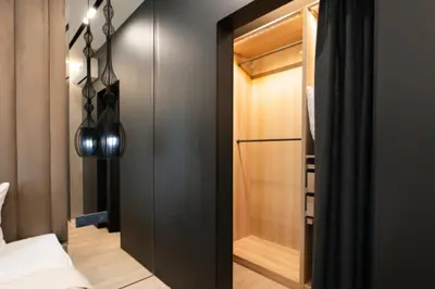 a bedroom with a black closet and a glass door at El home del belbala in Casablanca