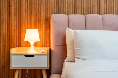 a bed with a nightstand with a lamp on it at Luxury cozy apartment in Casablanca