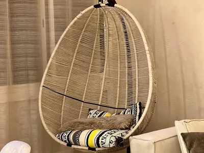 a wicker bird cage with pillows in it at Apartment Casa Marina - Borgone, Ocean & Hassan II Views in Casablanca