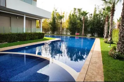 a swimming pool in front of a house at KST Home-Heaven Beach Sidi Rahal in Sidi Rahal