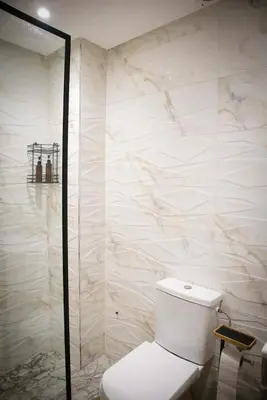 a white bathroom with a toilet and a shower at KST Home-Heaven Beach Sidi Rahal in Sidi Rahal