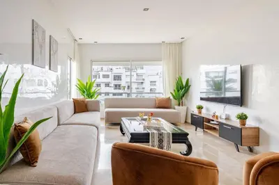 a living room with a couch and a table at Luxury Garden View Apartment Private Floor in Casablanca