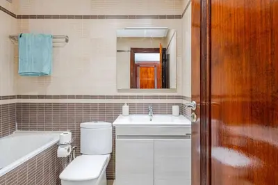 a bathroom with a toilet and a sink and a mirror at Luxury Garden View Apartment Private Floor in Casablanca