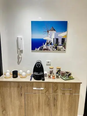 a counter with a picture of a windmill on the wall at Salam Beach in Pont Blondin