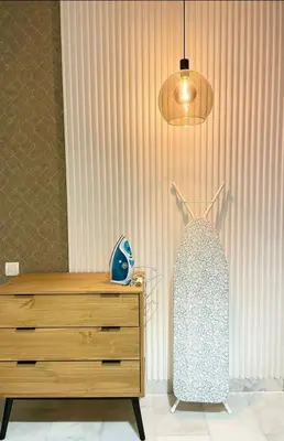 a bedroom with a dresser and a light fixture at A102 Studio cosy & chic in Casablanca