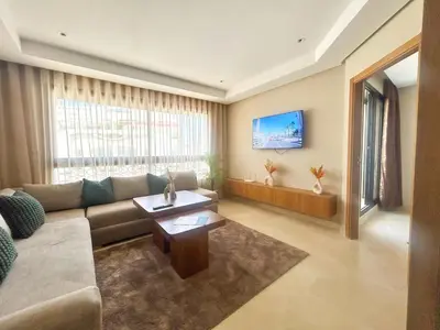 a living room with a couch and a table at Small Cozy Nest in Quiet Area - Central with Balcony in Casablanca