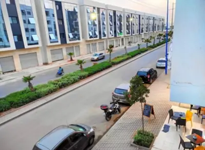 a view of a street with cars parked on the side of a building at A 2min hôpital M6,Proche d'Aéroport et la gare bouskoura in Bouskoura
