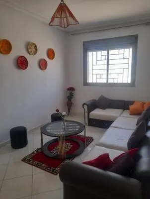 a living room with a couch and a table at A 2min hôpital M6,Proche d'Aéroport et la gare bouskoura in Bouskoura