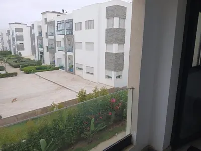 a view of a building from a balcony at Vakantie app charmante Harhoura in Temara