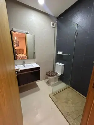 a bathroom with a shower and a sink and a toilet at Maison à louer à Mohammedia in Mohammedia