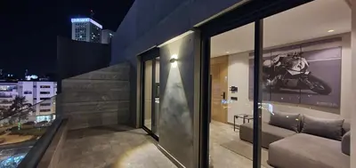 a balcony of a building with a motorcycle on the wall at Maârif Penthouse in Casablanca