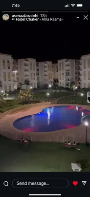 a picture of a large swimming pool at night at Beautiful 2 bedrooms apartment in Bouznika in Bouznika