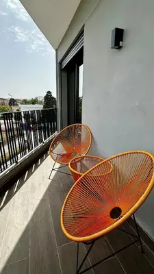two orange chairs sitting on a balcony at The Hidden Secret in Casablanca