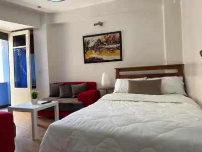 a bedroom with a bed and a red couch at Appartement au centre ville pour les mariés seulement in Rabat
