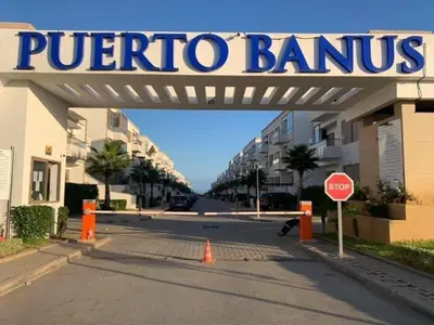 a sign over a street with a stop sign at Puerto Banus in Mansouria