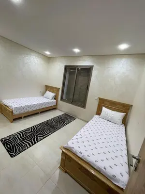 a bedroom with two beds and a window at Puerto Banus in Mansouria