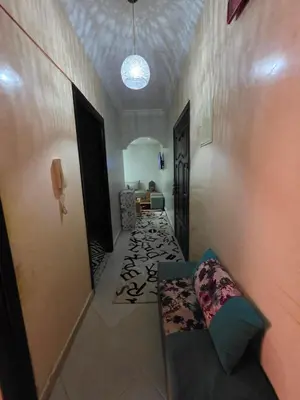 a hallway with a couch and a hallway with a room with a hallway at Appartement souka fitness in Bouznika