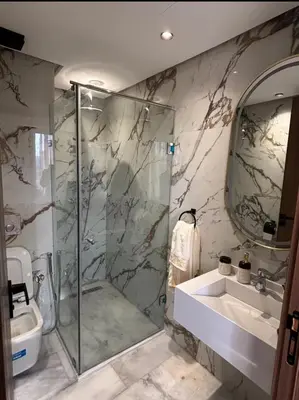 a bathroom with a shower and a sink and a mirror at Stay luxe in Casablanca