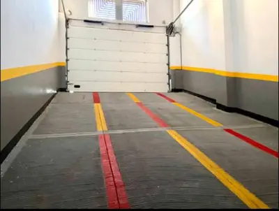 a garage with a white door and red and yellow lines at Stay luxe in Casablanca