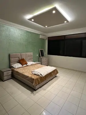 a bedroom with a bed and a flat screen tv at Appart a 1 minutes de la plage in Casablanca