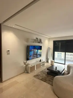 a living room with a couch and a flat screen tv at Appartement maarif in Casablanca