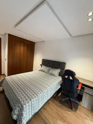 a bedroom with a bed and a desk and a chair at Appartement maarif in Casablanca
