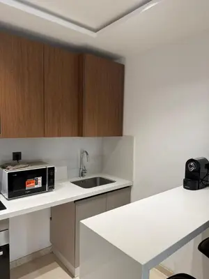 a kitchen with a sink and a microwave at Appartement maarif in Casablanca
