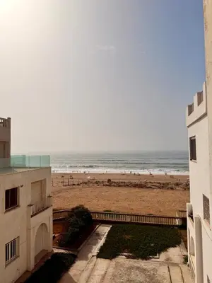 a view of the beach from the balcony of a building at Luxury Apartment Ocean View and Private Beach Ain Diab in Casablanca
