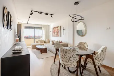 a living room with a table and a couch at Au Petit Port Balcony & Sea view 5 mn from casa-port in Casablanca