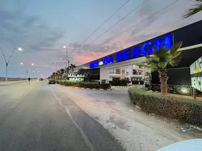 an empty street in front of a building at Sunset Malaga beach house in Mansouria