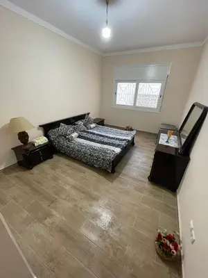 a bedroom with a bed and a large window at Cozy Condo in Rabat in Rabat