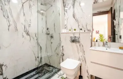 a bathroom with a shower and a toilet and a sink at Studio vert chic au cœur de Casablanca in Casablanca