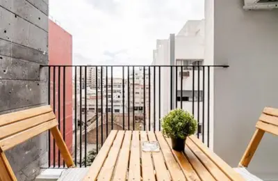 a balcony with a wooden bench and a plant at Studio vert chic au cœur de Casablanca in Casablanca