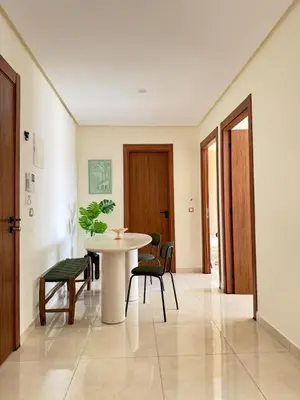 a dining room with a table and chairs at Appartement moderne avec piscine, 2 chambres in Bouznika