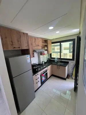 a kitchen with a refrigerator and a stove at apartment in sidi rahal in Sidi Rahal