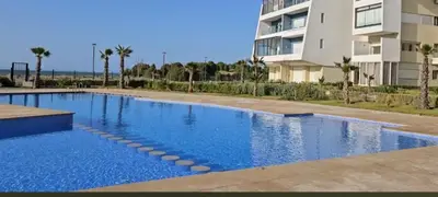 a swimming pool in front of a building at Dokkali